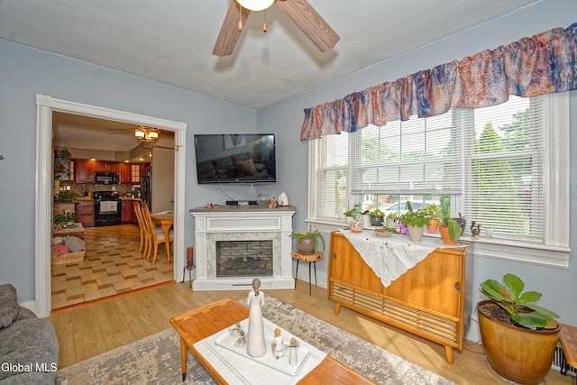 1752 Van Cortland St, Schenectady, NY 12303 - living room with wood finished floors, a ceiling fan, and a fireplace with raised hearth