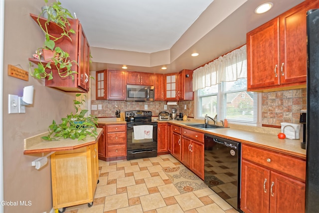 1752 Van Cortland St, Schenectady, NY 12303 - kitchen featuring black appliances, light countertops, decorative backsplash, and recessed lighting