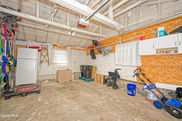 1752 Van Cortland St, Schenectady, NY 12303 - garage with freestanding refrigerator and a garage door opener