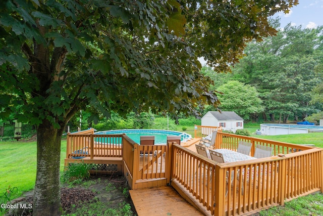 125 Halfmoon Dr, Guilderland, NY 12009 - deck featuring an outdoor pool, an outbuilding, and a lawn