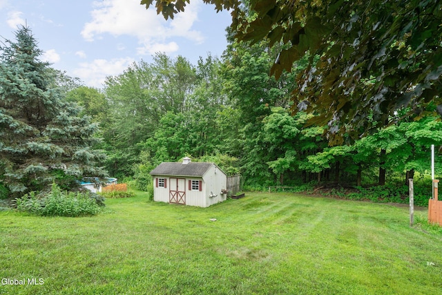 125 Halfmoon Dr, Guilderland, NY 12009 - view of grassy yard featuring a storage shed and a wooded view