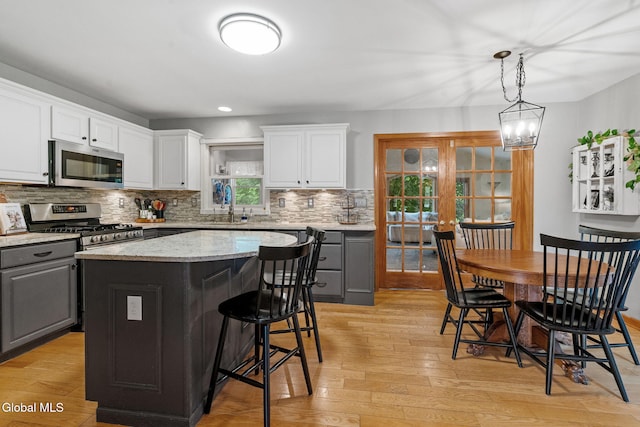 125 Halfmoon Dr, Guilderland, NY 12009 - kitchen featuring gray cabinets, stainless steel appliances, a center island, light wood-style flooring, and recessed lighting