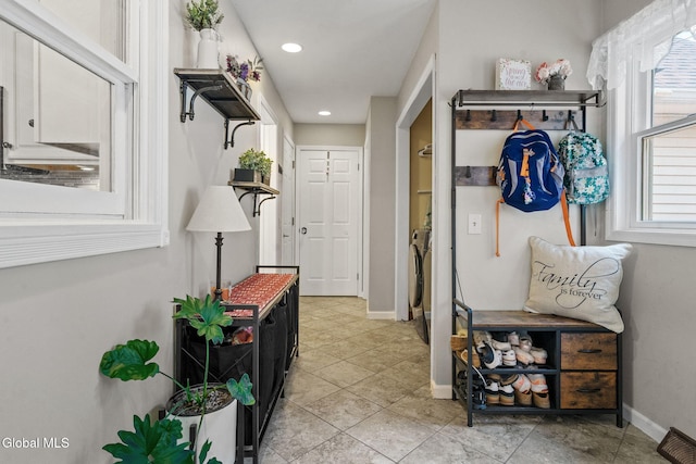 125 Halfmoon Dr, Guilderland, NY 12009 - hallway with washer and clothes dryer, healthy amount of natural light, recessed lighting, and light tile patterned floors