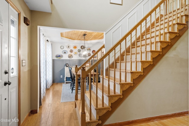 125 Halfmoon Dr, Guilderland, NY 12009 - stairs with plenty of natural light, hardwood / wood-style flooring, and a chandelier