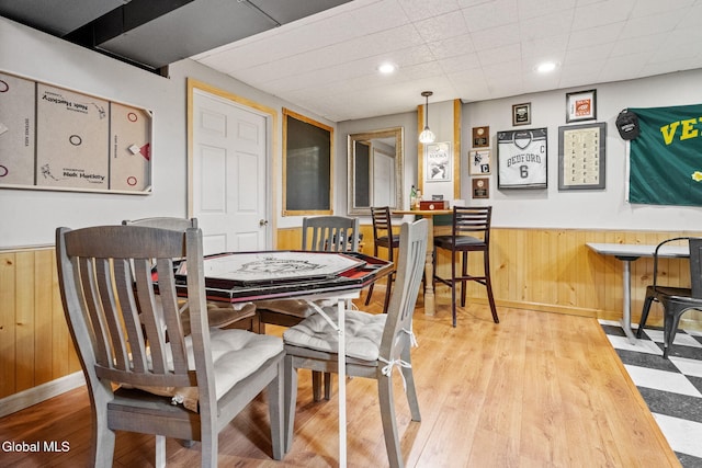 125 Halfmoon Dr, Guilderland, NY 12009 - dining room featuring wainscoting, wood walls, and wood finished floors