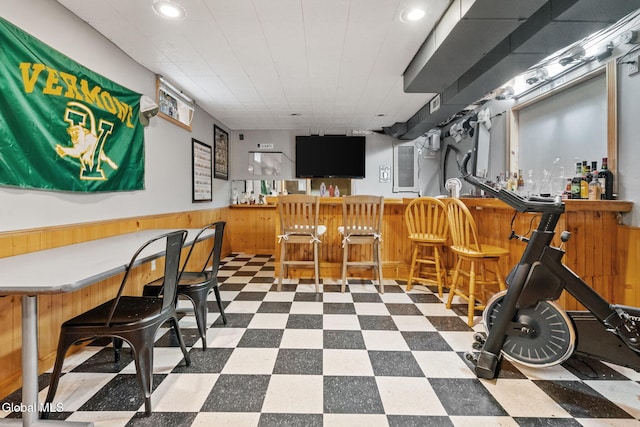 125 Halfmoon Dr, Guilderland, NY 12009 - indoor bar with tile patterned floors, a wainscoted wall, wooden walls, and recessed lighting