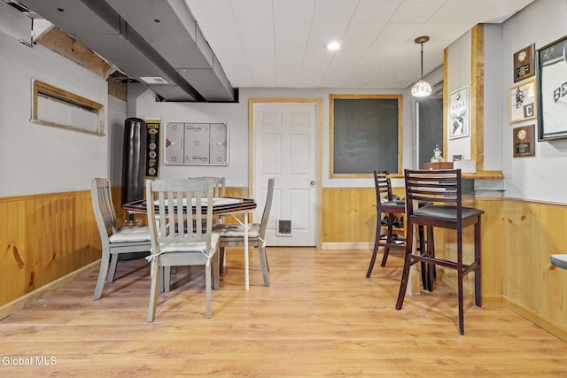 125 Halfmoon Dr, Guilderland, NY 12009 - dining area featuring wooden walls, wainscoting, and light wood-style floors