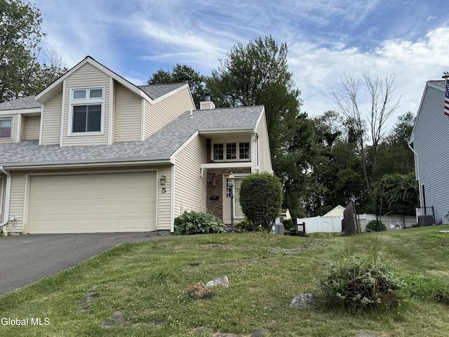 5 Crowsnest Ct, Halfmoon, NY 12188 - view of front of home featuring driveway, roof with shingles, an attached garage, and a chimney