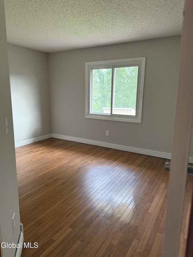 5 Crowsnest Ct, Halfmoon, NY 12188 - spare room with wood-type flooring and a textured ceiling