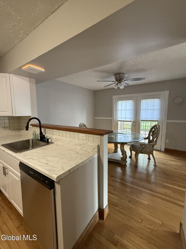 5 Crowsnest Ct, Halfmoon, NY 12188 - kitchen featuring stainless steel dishwasher, a textured ceiling, a peninsula, white cabinetry, and ceiling fan