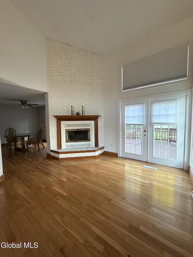 5 Crowsnest Ct, Halfmoon, NY 12188 - unfurnished living room featuring a high ceiling, wood finished floors, a fireplace, and ceiling fan
