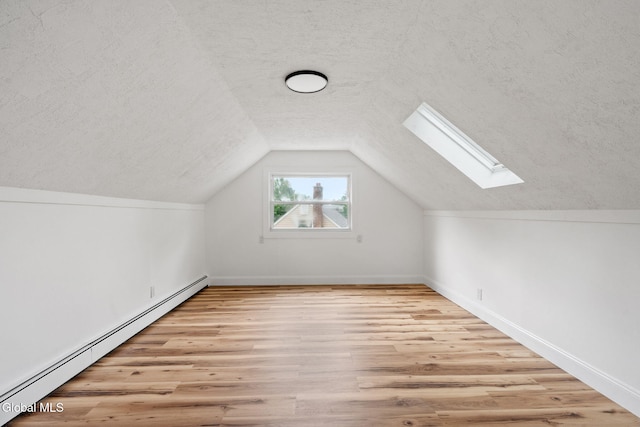 10 Perry Ave, Colonie, NY 12110 - bonus room with baseboard heating, a skylight, a textured ceiling, wood finished floors, and vaulted ceiling
