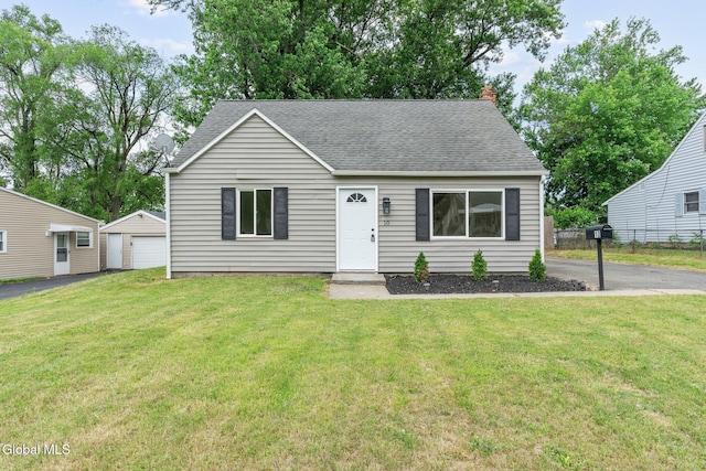 10 Perry Ave, Colonie, NY 12110 - view of front of home featuring a shingled roof, an outbuilding, a chimney, and a detached garage