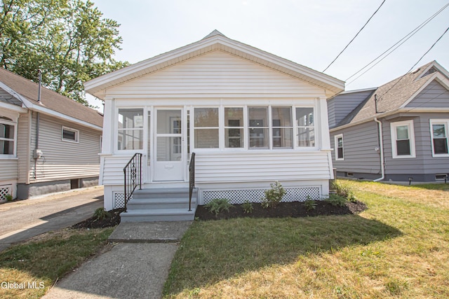 1628 Hawthorne St, Schenectady, NY 12303 - view of front of home featuring a sunroom, a front lawn, and entry steps