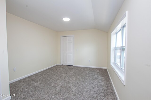 1628 Hawthorne St, Schenectady, NY 12303 - unfurnished bedroom with vaulted ceiling, carpet flooring, and a closet