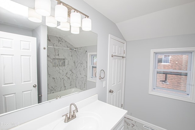 1628 Hawthorne St, Schenectady, NY 12303 - full bathroom with vanity, marble look tile flooring, vaulted ceiling, tub / shower combination, and plenty of natural light