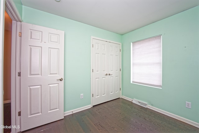 50 Sandy Ln, Bethlehem, NY 12158 - unfurnished bedroom with dark wood-style flooring and a closet