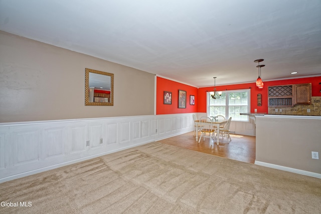 50 Sandy Ln, Bethlehem, NY 12158 - spare room featuring carpet flooring, a chandelier, and a wainscoted wall