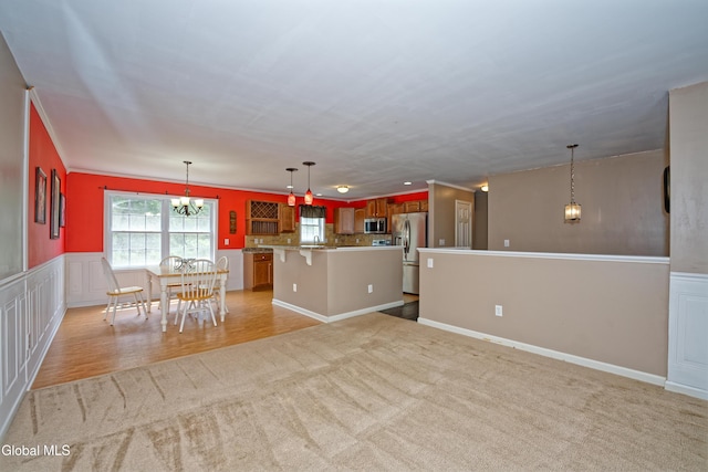 50 Sandy Ln, Bethlehem, NY 12158 - kitchen featuring stainless steel appliances, light carpet, a chandelier, a center island, and a breakfast bar
