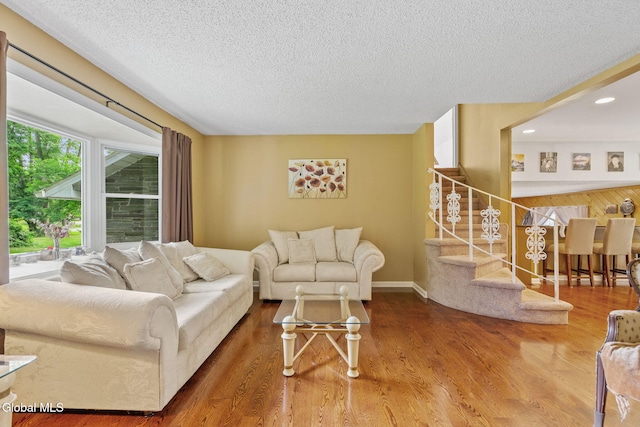 145 Sylvia Ln, Rotterdam, NY 12306 - living room featuring a textured ceiling, stairway, wood finished floors, and recessed lighting