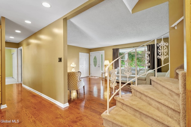 145 Sylvia Ln, Rotterdam, NY 12306 - foyer entrance featuring wood finished floors, stairs, recessed lighting, and a textured ceiling
