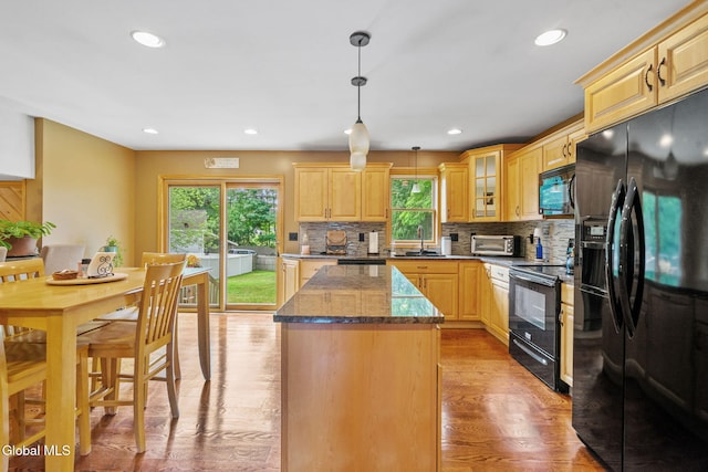 145 Sylvia Ln, Rotterdam, NY 12306 - kitchen with black appliances, plenty of natural light, a kitchen island, decorative backsplash, and recessed lighting