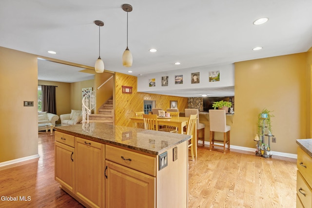 145 Sylvia Ln, Rotterdam, NY 12306 - kitchen featuring open floor plan, wood walls, recessed lighting, light wood-style flooring, and a kitchen island