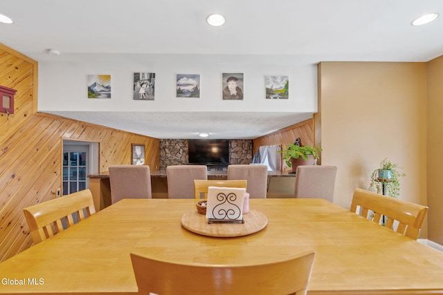 145 Sylvia Ln, Rotterdam, NY 12306 - dining space with wooden walls, a fireplace, and recessed lighting