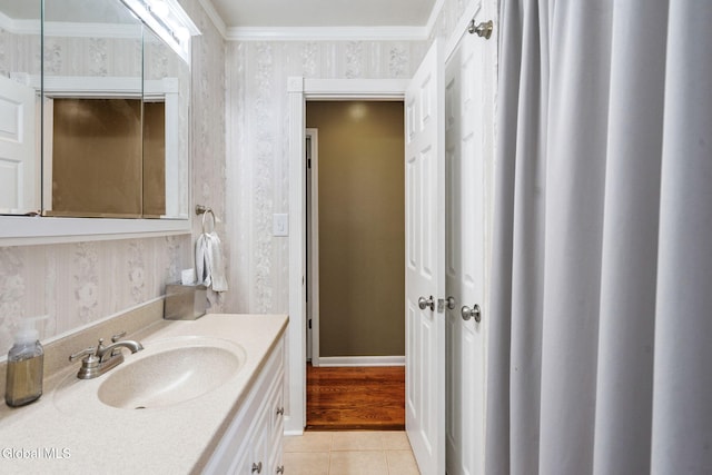 145 Sylvia Ln, Rotterdam, NY 12306 - bathroom with wallpapered walls, vanity, tile patterned floors, and ornamental molding