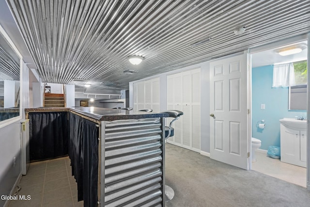 145 Sylvia Ln, Rotterdam, NY 12306 - kitchen featuring tile patterned floors, dark countertops, and carpet flooring