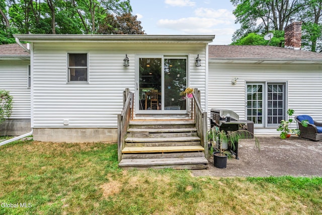 145 Sylvia Ln, Rotterdam, NY 12306 - back of house with a yard, a patio area, a chimney, and roof with shingles