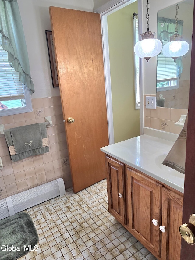 12 Winkel Way, Clifton Park, NY 12019 - bathroom featuring a baseboard heating unit, healthy amount of natural light, vanity, and tile walls
