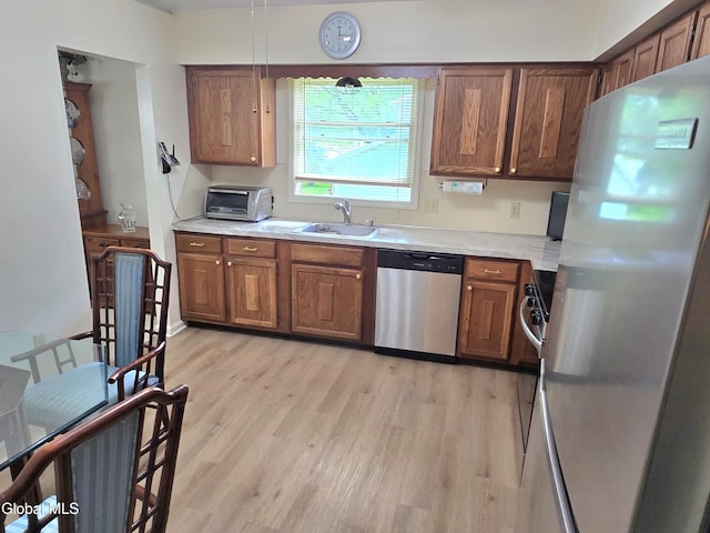 12 Winkel Way, Clifton Park, NY 12019 - kitchen with stainless steel appliances, light wood-style flooring, light countertops, and brown cabinets