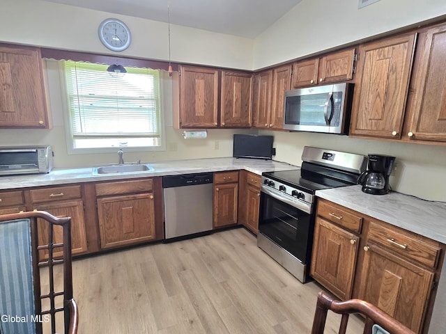 12 Winkel Way, Clifton Park, NY 12019 - kitchen with appliances with stainless steel finishes, light wood-style floors, light countertops, and brown cabinets