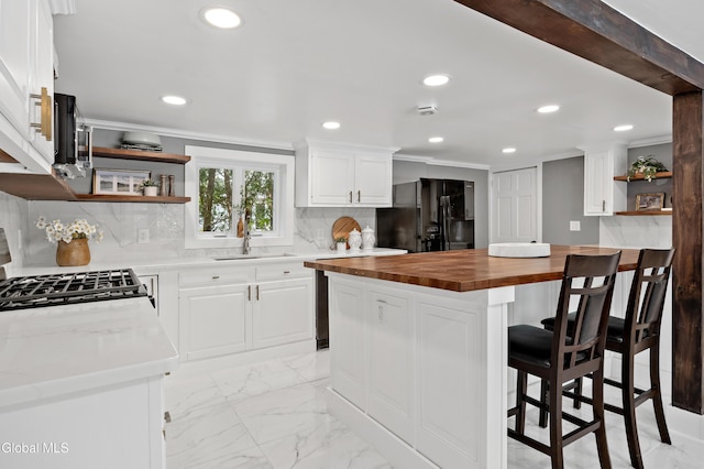 84 Glenwood Ave, Queensbury, NY 12804 - kitchen with black fridge with ice dispenser, open shelves, wood counters, recessed lighting, and crown molding