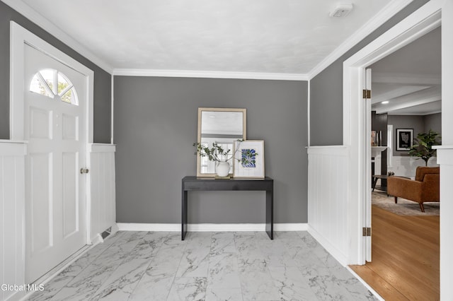 84 Glenwood Ave, Queensbury, NY 12804 - entryway with marble look tile flooring, wainscoting, ornamental molding, a decorative wall, and a fireplace