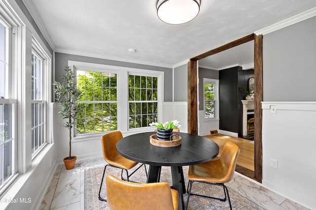 84 Glenwood Ave, Queensbury, NY 12804 - dining room featuring light marble finish floors, crown molding, a wainscoted wall, and a fireplace