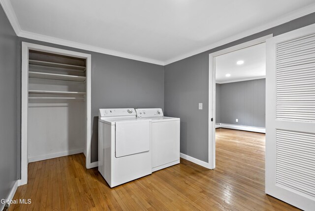 84 Glenwood Ave, Queensbury, NY 12804 - laundry room featuring a baseboard heating unit, separate washer and dryer, ornamental molding, and light wood finished floors