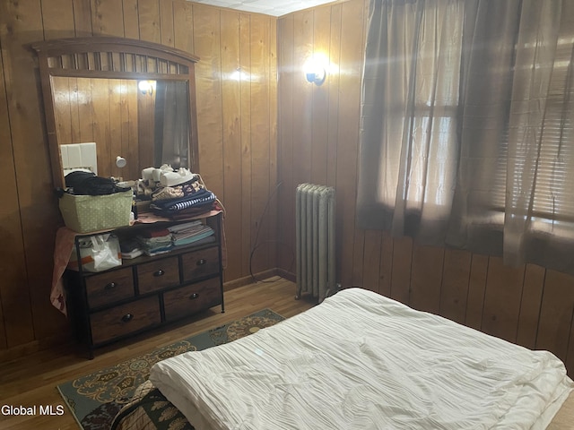 1341 7th Ave, Schenectady, NY 12303 - bedroom featuring radiator, wood finished floors, and wood walls