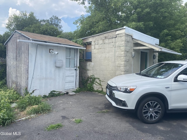 1341 7th Ave, Schenectady, NY 12303 - view of property exterior with concrete block siding and a storage unit