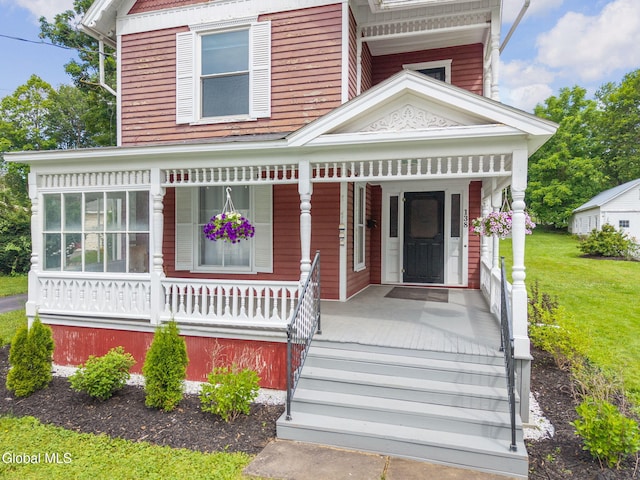 138 Elm St, Cobleskill, NY 12043 - view of front of house with a porch and a front yard