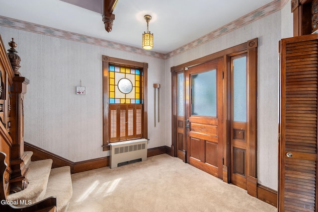 138 Elm St, Cobleskill, NY 12043 - carpeted entrance foyer with radiator heating unit, wallpapered walls, and stairway