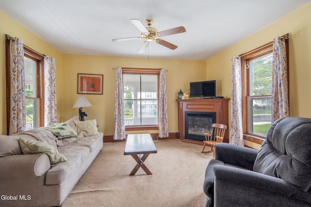 138 Elm St, Cobleskill, NY 12043 - living area with a glass covered fireplace, light colored carpet, and ceiling fan