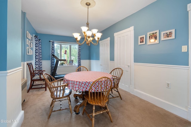 138 Elm St, Cobleskill, NY 12043 - carpeted dining area featuring a chandelier, wainscoting, and radiator