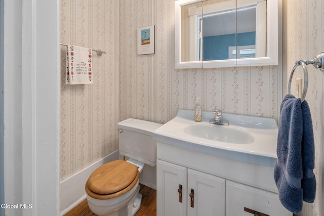 138 Elm St, Cobleskill, NY 12043 - bathroom featuring vanity, wallpapered walls, and wood finished floors