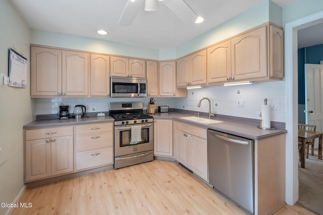 138 Elm St, Cobleskill, NY 12043 - kitchen with appliances with stainless steel finishes, light brown cabinetry, backsplash, light wood-style flooring, and recessed lighting