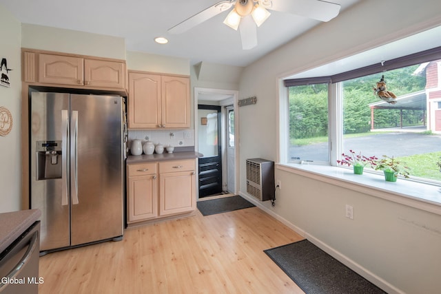 138 Elm St, Cobleskill, NY 12043 - kitchen with appliances with stainless steel finishes, light brown cabinetry, heating unit, light wood-style floors, and plenty of natural light