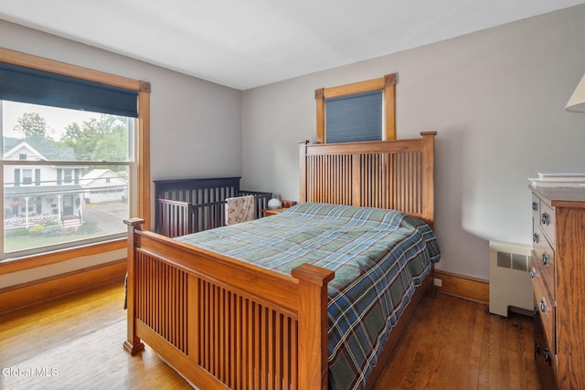 138 Elm St, Cobleskill, NY 12043 - bedroom with radiator and wood finished floors