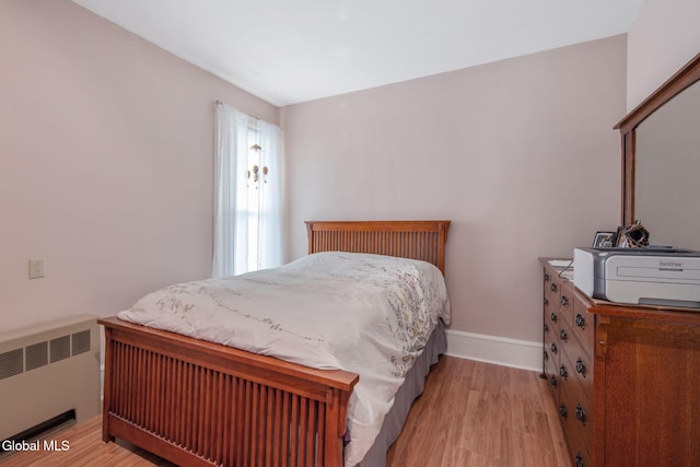138 Elm St, Cobleskill, NY 12043 - bedroom with radiator heating unit and wood finished floors