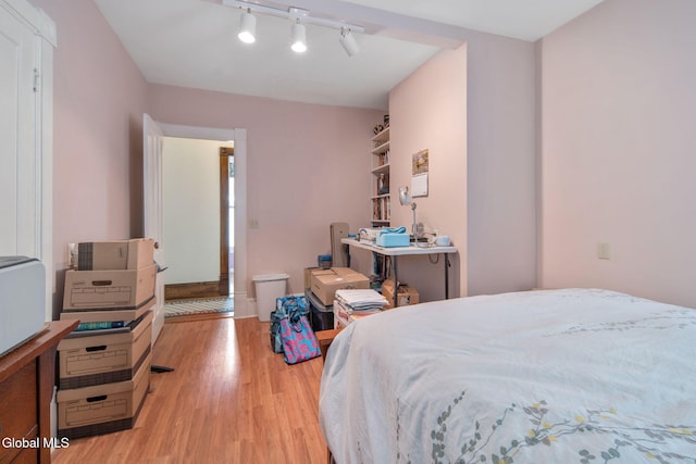 138 Elm St, Cobleskill, NY 12043 - bedroom with wood finished floors and rail lighting
